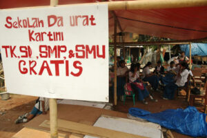Meski di lapangan terbuka dan bertenda terpal plastic, anak-anak ini siap memulai pelajaran. (bmzIMAGES/Basri Marzuki)