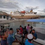 Donggala, Central Sulawesi, Indonesia (February 5, 2019): Residents watch preparations for the launch of the KM Sabuk Nusantara 39 ship back to the sea in Wani Port, Donggala, Central Sulawesi, Indonesia, Tuesday, February 5, 2019.