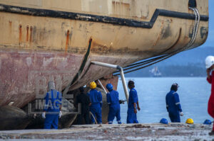 Donggala, Central Sulawesi, Indonesia (February 5, 2019): Workers prepare to launch KM Sabuk Nusantara 39 ship back to the sea in Wani Port, Donggala, Central Sulawesi, Indonesia, Tuesday, February 5, 2019. After being on land due to the tsunami waves hit Last September 28, 2018, finally the Sea Toll boat owned by PT. The Pelni was finally pulled back into the sea by being driven by an excavator and pulled by a tug boat. Most of the residents who lived around regretted that the ship should have remained on land as a memory that there had been a devastating tsunami in the region. bmzIMAGES/Basri Marzuki