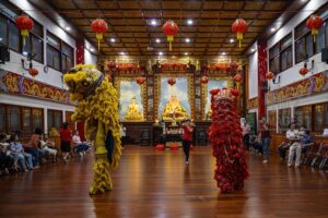 Chinese descendants took pictures during the lion dance performance after praying for the Chinese New Year at the Eka Dharma Manggala Temple in Palu, Central Sulawesi, Indonesia on January 24, 2020. Prayers are performed to welcome the Chinese Lunar New Year 2571/2020 and ask for blessings, safety and protection from the Yang Almighty. The lion dance attraction was also held as a symbol of good luck and blessings. (Photo by bmzIMAGES/Basri Marzuki)