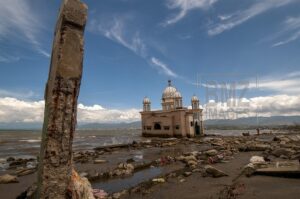 Palu, Central Sulawesi, Indonesia (7 February 2019) - This is the condition of the Arqam Baburrahman Mosque or Palu Floating Mosque after being hit by the tsunami on Kampung Lere Beach, Palu Bay, Central Sulawesi, Indonesia, Thursday, February 7, 2019. The tsunami that hit the coastal area also hit the mosque which was once one of the tourist icons in Palu City. The 121 square meter mosque did not collapse, but because the tsunami preceded by the earthquake resulted in a decline in land on the beach up to 1.5 meters and also sank some of the mosque's buildings. The bridge to the mosque that was built in 2011 was broken and shifted up to tens of meters, but could no longer be used. Many residents came to this place after the tsunami to see first hand the conditions and take photos. Although local residents intended to repair the mosque, the local government banned because the mosque was in the red zone of the tsunami disaster, which meant no construction could be done on it. (bmzIMAGES/Basri Marzuki)