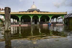 Donggala, Central Sulawesi, Indonesia (January 12): A mosque inundated by tidal floods or tides in the village of Tompe, Sirenja District, Donggala Regency, Central Sulawesi Province, Indonesia on January 12, 2020. Tidal floods that enter into residential areas it occurs every 15 days due to a decrease in land surface as deep as two meters due to the 7.4 magnitude earthquake centered in the village on September 28, 2018 then. Local residents are forced to flee to higher ground and return to their homes after the water has receded. This condition has been going on since one and a half years ago until now. bmzIMAGES/Basri Marzuki